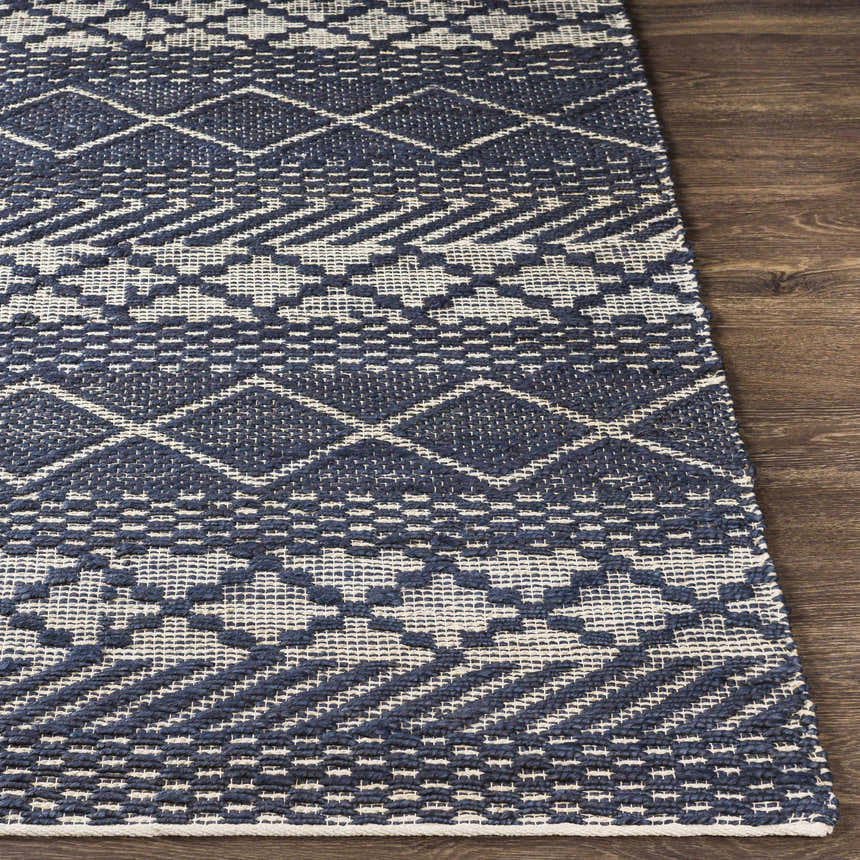Close-up of the hand woven Bunclody Jute Carpet. Light beige and navy geometric pattern on a textured jute rug. Front
