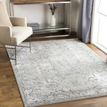 Living room scene with a Bushnell Thick Luxe Boutique Rug in dusty sage and beige tones. Roomscene-Rectangle