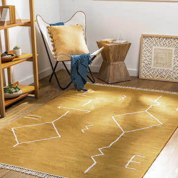 Living room scene with a mustard yellow Bushra Area Rug featuring a white geometric design. Roomscene-Rectangle