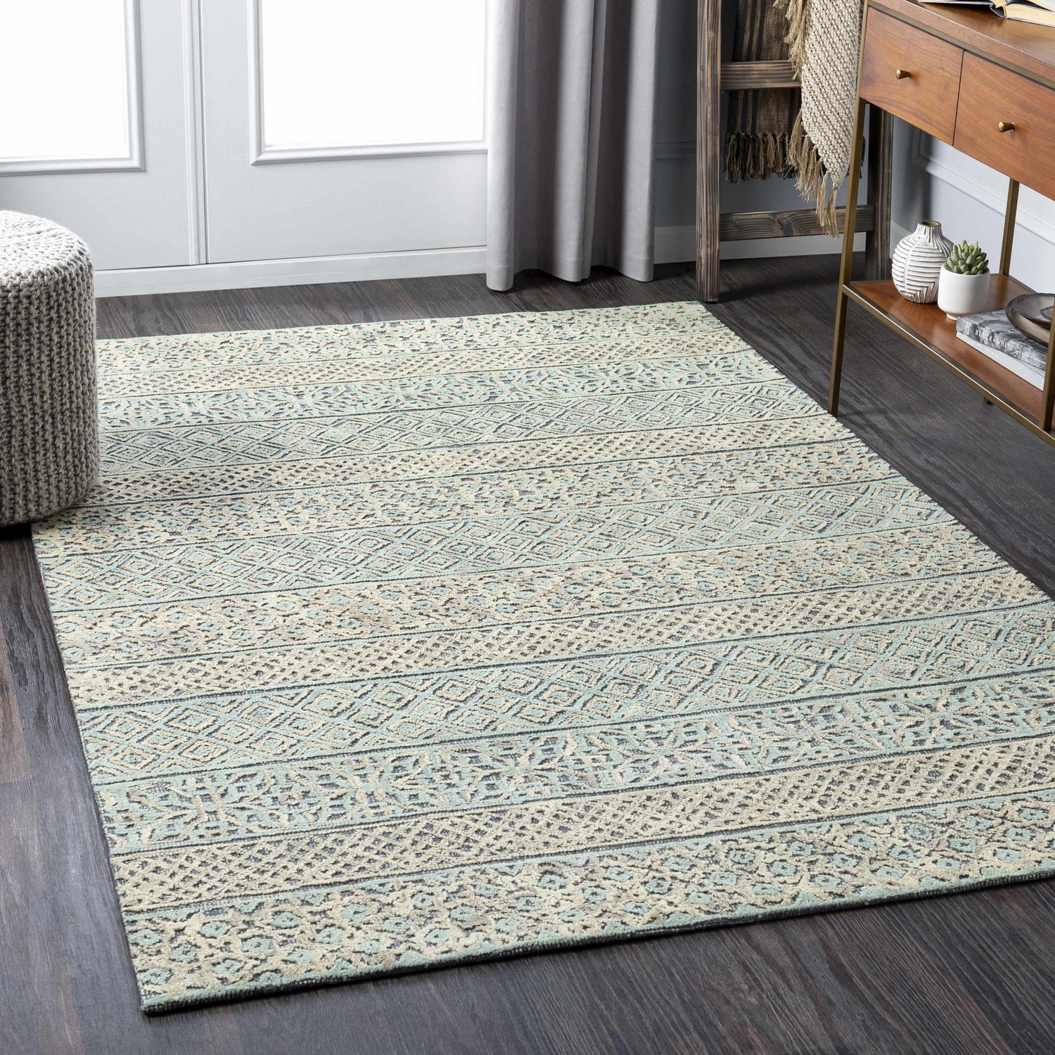 Living room scene with a beige and sage Byron Area Rug, wood floors, and modern farmhouse decor. Roomscene-Rectangle