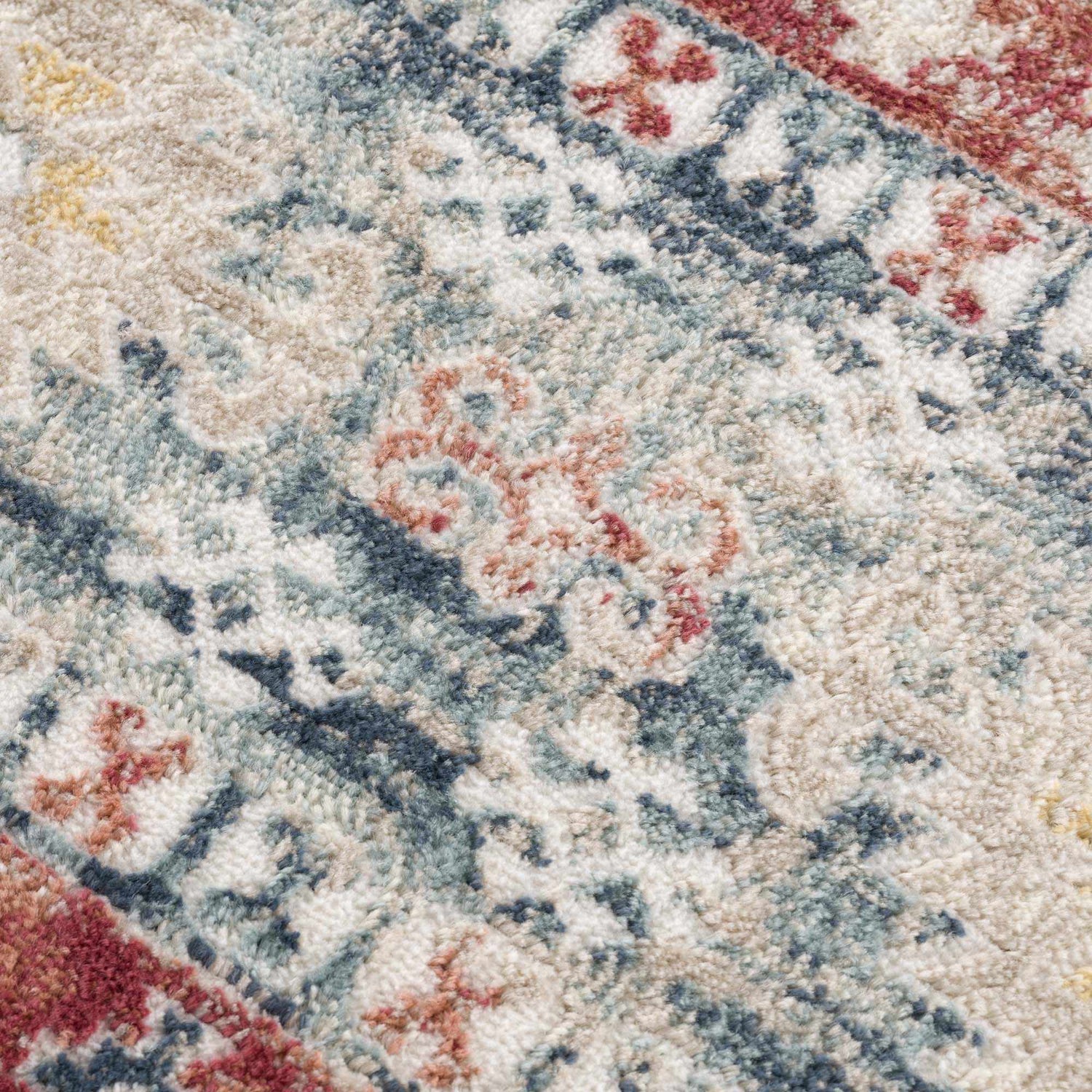 Close-up of the Bindi Blue & Rose Area Rug showing its traditional, Southwestern pattern and soft, textured weave. Texture