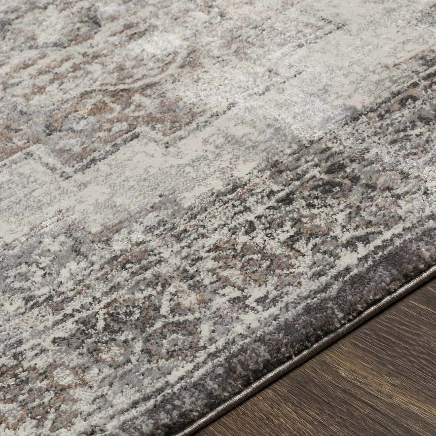 Close-up of the textured Manaring Charcoal Luxe Thick Area Rug, showing its charcoal, cream, and brown tones. Texture