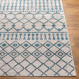 Close-up of the Cabognon Washable Area Rug. Features a geometric pattern in blue, ink blue, light beige, and light gray. Front