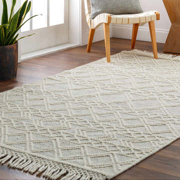 Entryway scene with Cameo Scandi Wool Rug in bone color, geometric design, and fringe detail on hardwood floor. Roomscene-Rectangle