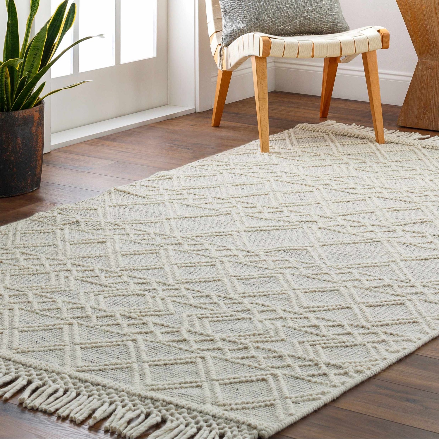 Entryway scene with Cameo Scandi Wool Rug in bone color, geometric design, and fringe detail on hardwood floor. Roomscene-Rectangle
