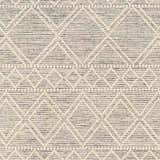 Close-up of Cameo Scandi Wool Rug. Bone geometric diamond pattern on a cloud gray and dark gray hand woven texture. Swatch