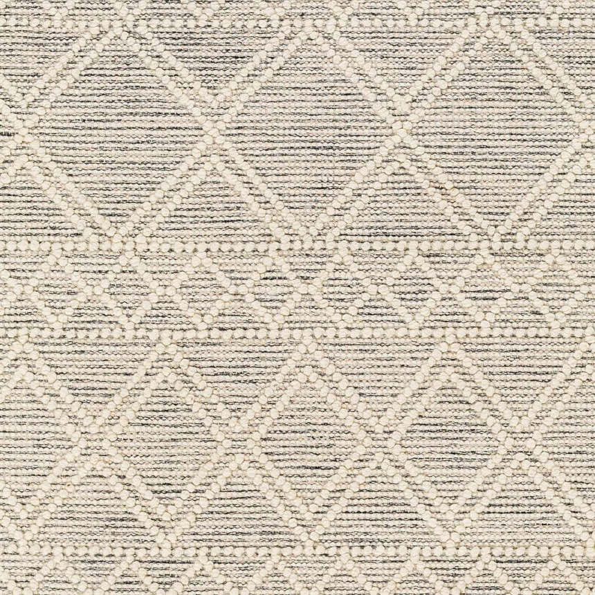 Close-up of Cameo Scandi Wool Rug. Bone geometric diamond pattern on a cloud gray and dark gray hand woven texture. Swatch
