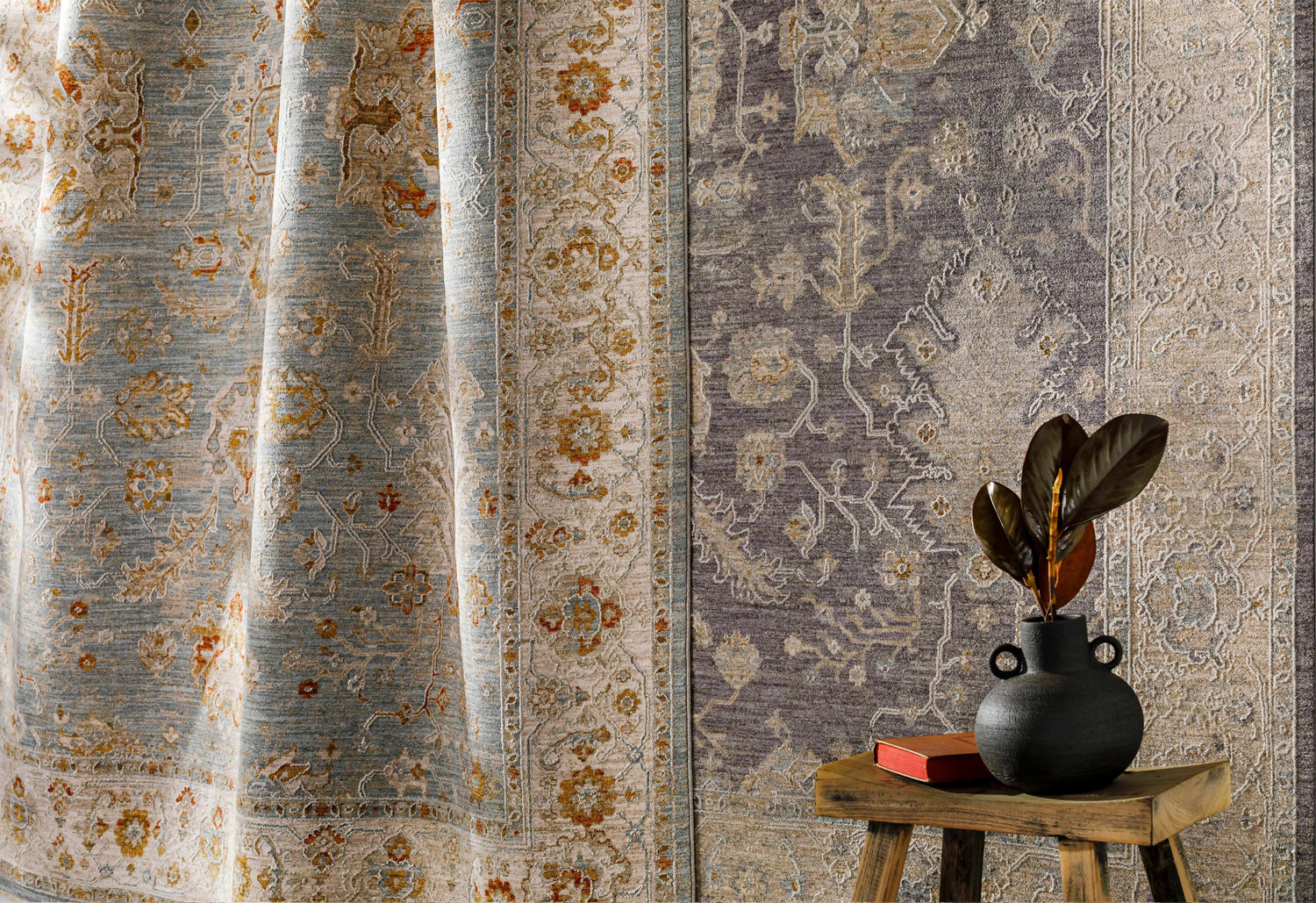 Close-up of Camrose Thick Luxe Statement Rug in brick red, charcoal, and light beige with a traditional floral pattern. Styleshot