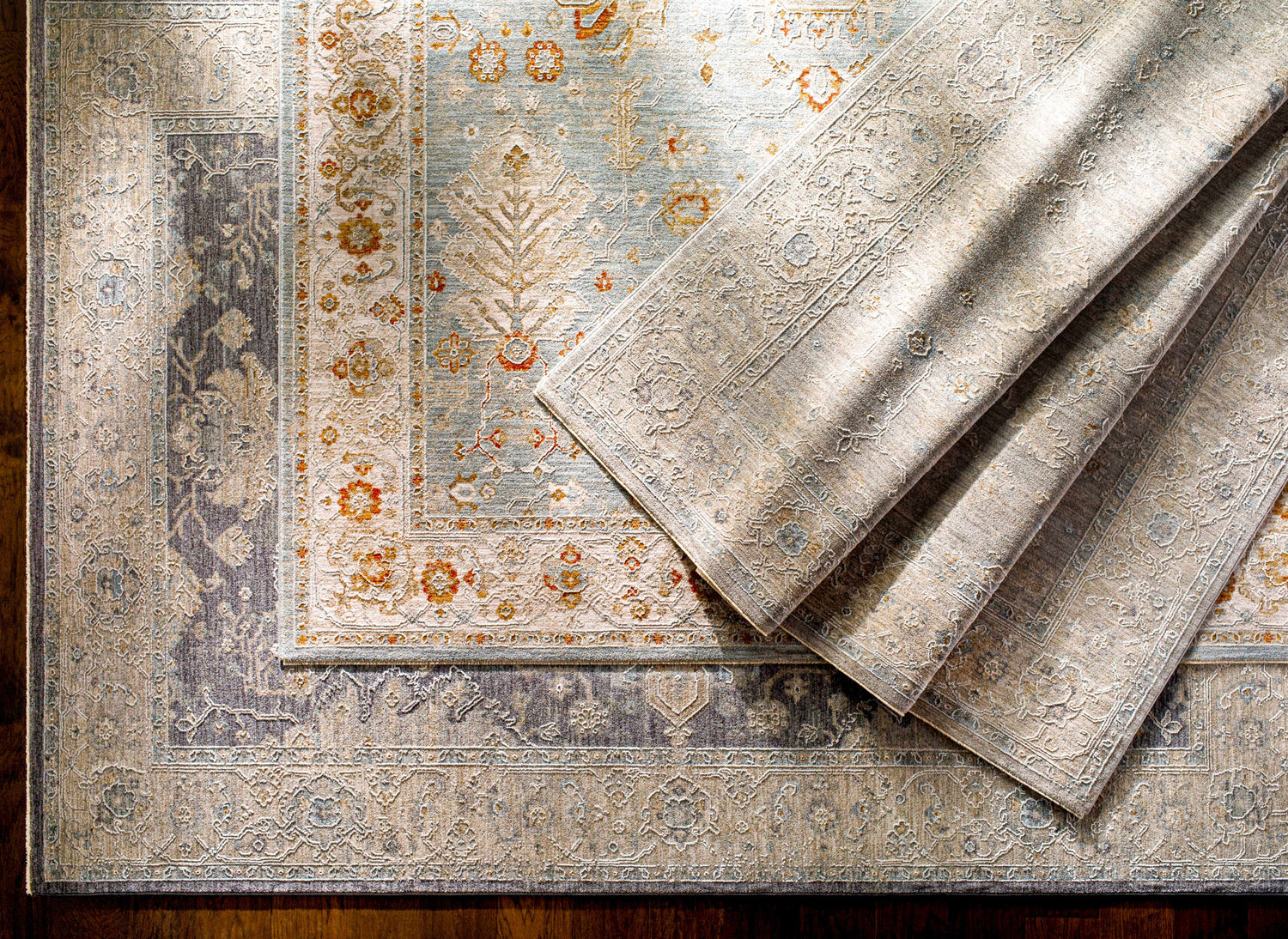 Close-up of the Camrose Thick Luxe Statement Rug showing the traditional pattern, brick red, charcoal, and light beige colors. Styleshot