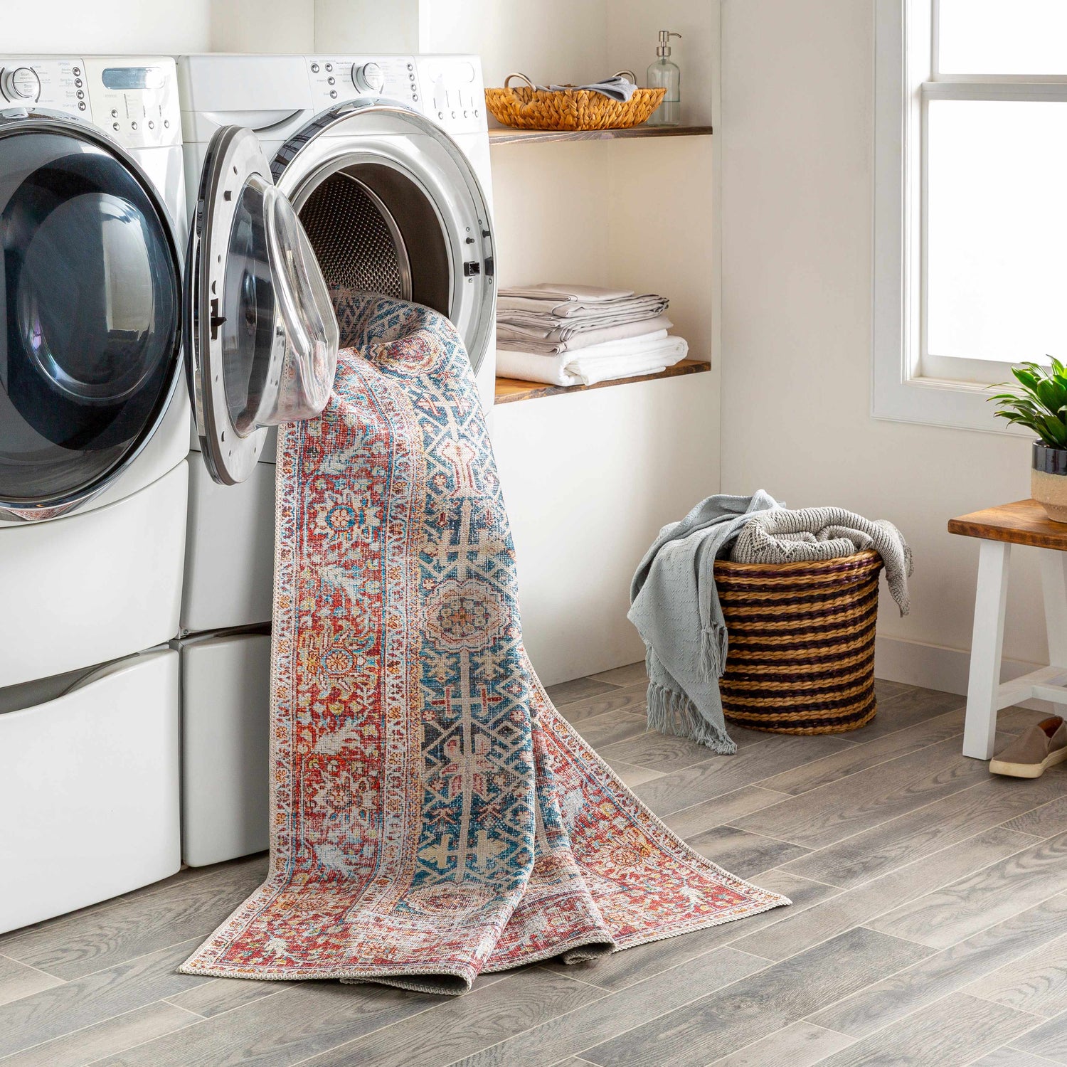 Laundry room scene with a Rust Catadupa Distressed Washable Area Rug coming out of the washing machine. Easy rug cleaning. Washing-Machine