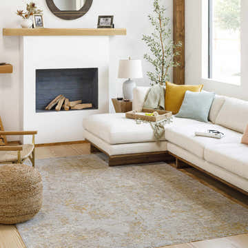Living room scene with Cayhagan Mustard Luxe Rug, white sectional, fireplace, and natural light. Contemporary style. Roomscene-Rectangle