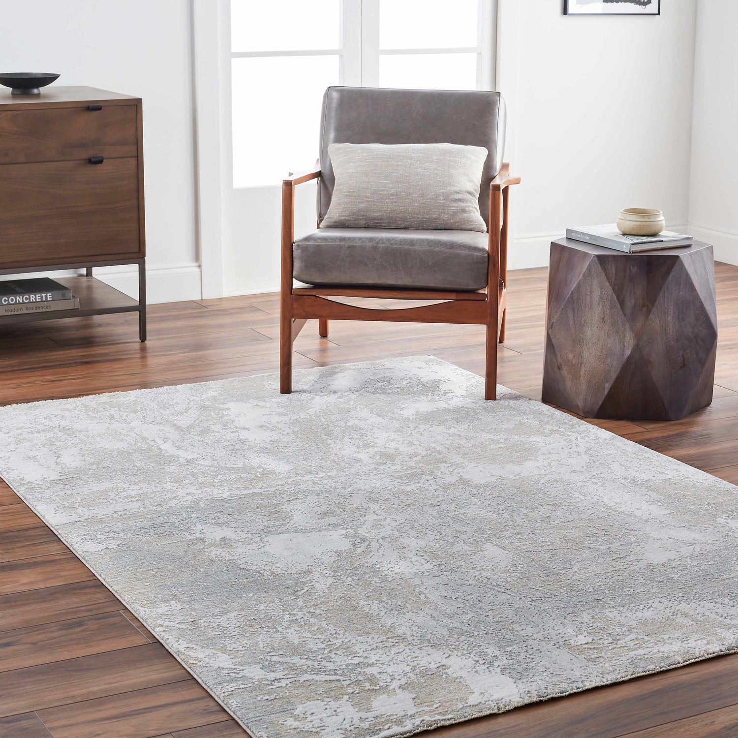 Living room scene with a gray Cady Thick Luxe Area Rug, wood floors, gray chair, and wood accent furniture. Roomscene-Rectangle