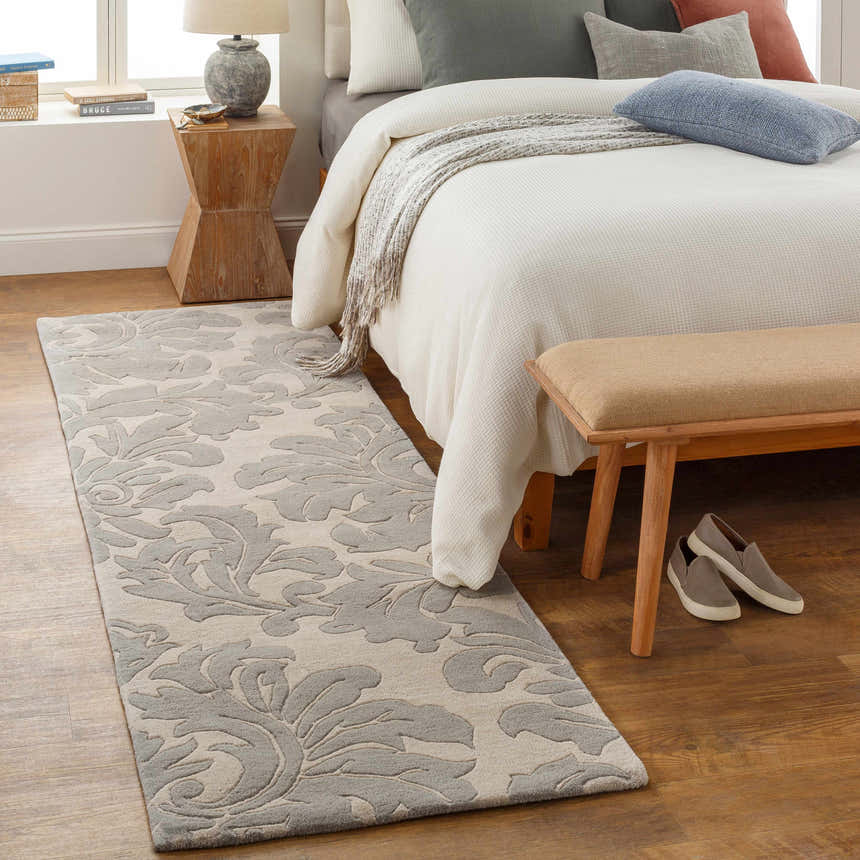 Bedroom scene with a gray and ivory Cementon Area Rug runner, wood floors, and a bed with neutral pillows. Roomscene-Runner