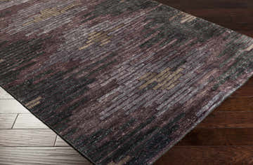 Close-up of the Cherokee Carpet - Clearance. Hand-knotted viscose rug with charcoal, gray, olive, lilac, and plum colors. Contemporary style. Corner