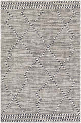 Close-up of the Cheverly Area Rug. Black, gray, and white diamond pattern with a textured, machine-woven construction. Design-Rectangle-5373