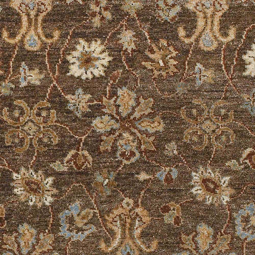 Close-up of the Chinle Premium Wool Area Carpet in brick red and brown with a traditional floral pattern. Swatch