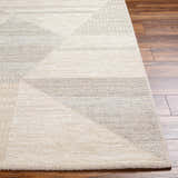 Close-up of the Chizu Geometric Neutral Luxe Rug, showcasing its bone and gray geometric pattern and soft, textured weave. Front