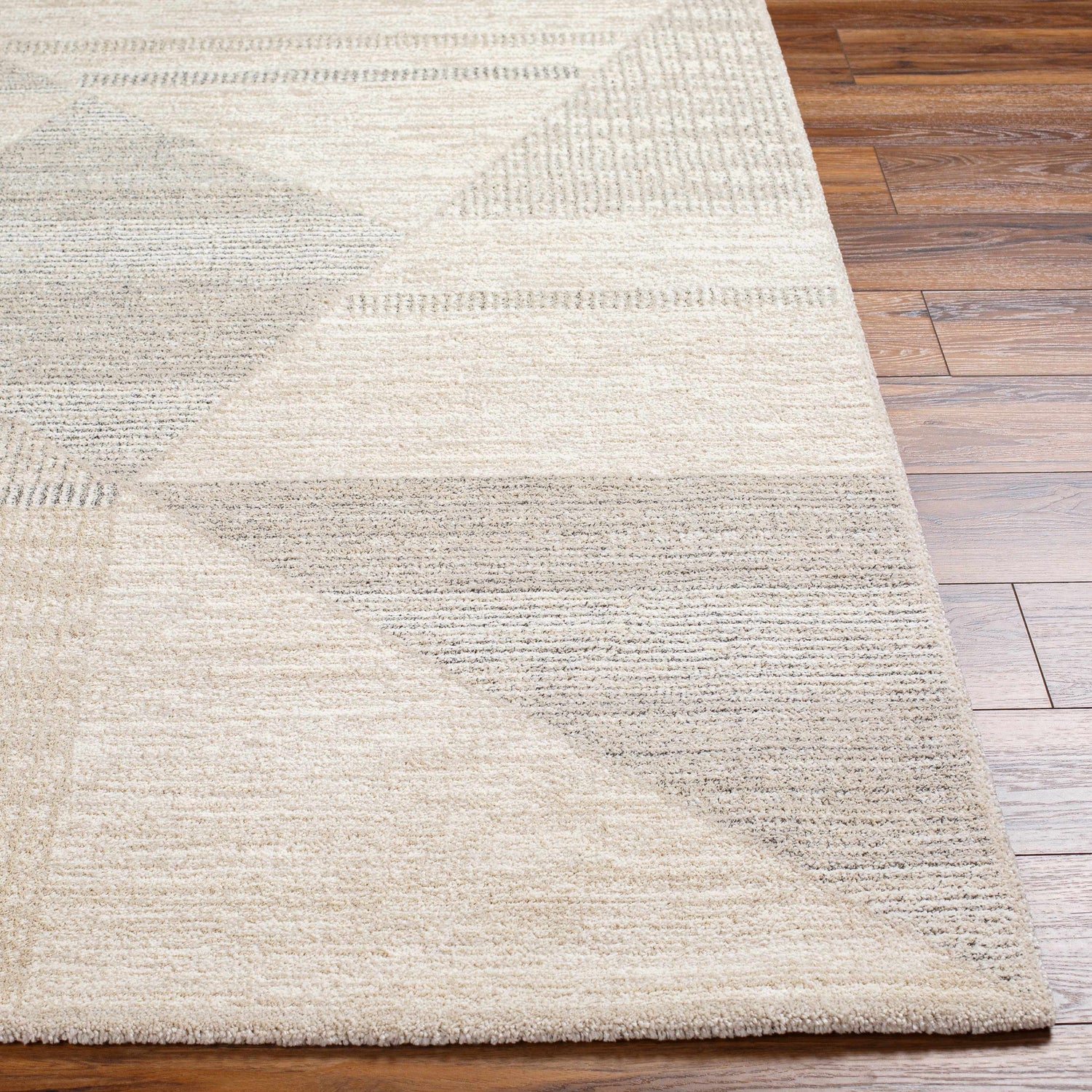 Close-up of the Chizu Geometric Neutral Luxe Rug, showcasing its bone and gray geometric pattern and soft, textured weave. Front