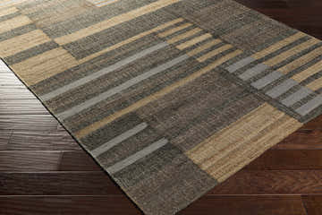 Close-up of the Chambers Area Carpet showing its brown, tan, and gray geometric pattern and jute texture. Corner