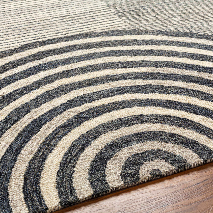 Close-up of the hand-tufted Chantesuta Modern Wool Rug. Features a contemporary striped pattern in beige, black, and lambswool hues. Texture