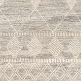 Close-up of the Hemingway Wool Rug. Bone and cloud gray rug with geometric pattern and hand-woven texture. Swatch