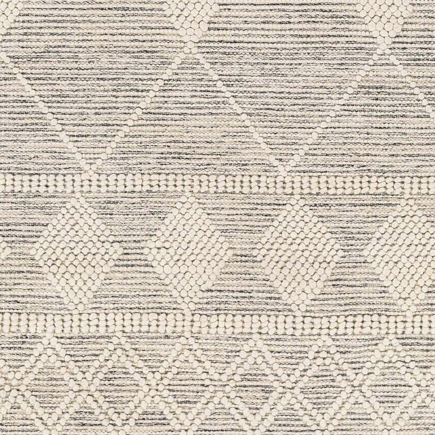 Close-up of the Hemingway Wool Rug. Bone and cloud gray rug with geometric pattern and hand-woven texture. Swatch