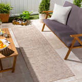 Outdoor patio scene with Coolville Brown Flatweave Area Carpet, wooden furniture, plants, and neutral color palette. Roomscene-Runner