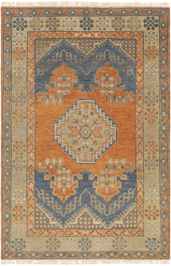 Close-up of the hand-knotted Charmhaven Area Rug. Features blue, brown, and burnt orange traditional Southwestern patterns. Design-Rectangle-69
