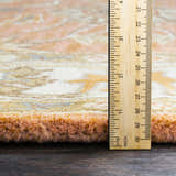 Close-up of the plush texture and pile height of the Caesar Hand Tufted Burnt Orange Wool Carpet, measured with a ruler. Pile
