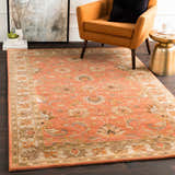 Living room scene with a Caesar Hand Tufted Burnt Orange Wool Carpet, orange chair, gold side table, and modern art. Roomscene-Rectangle