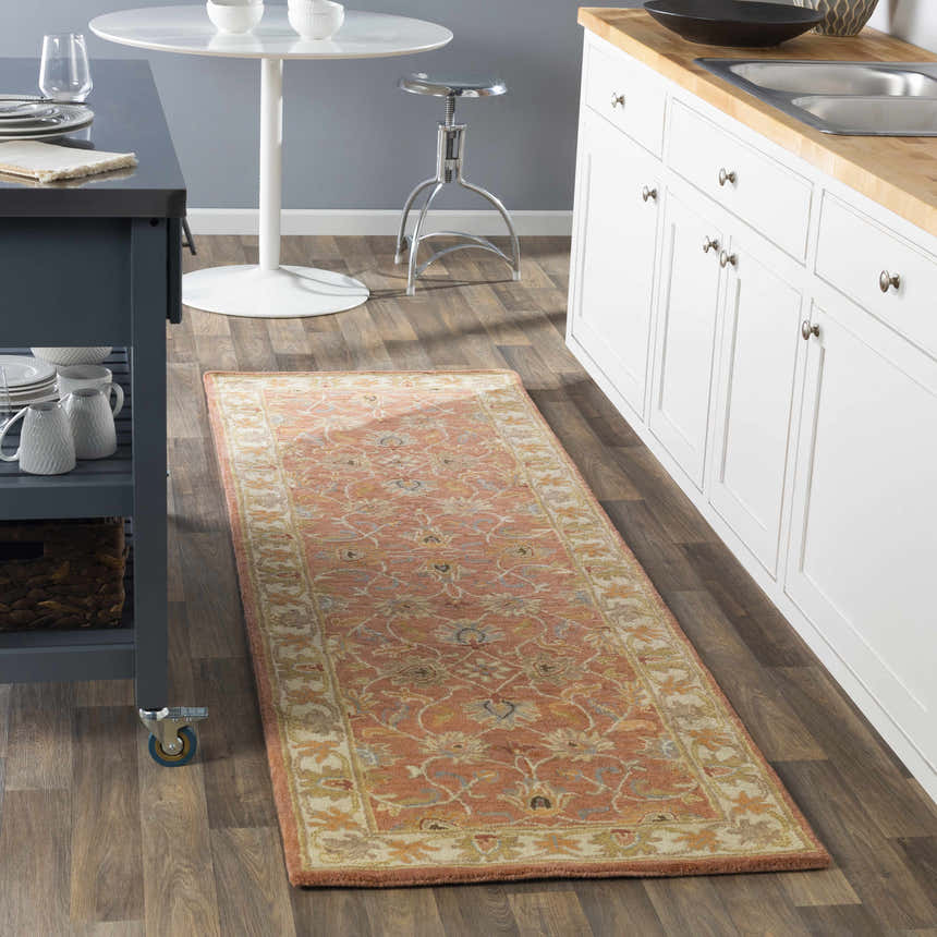 Kitchen scene with Caesar Hand Tufted Burnt Orange Wool Runner Rug. Features white cabinets, wood floors, and a gray kitchen island. Roomscene-Runner
