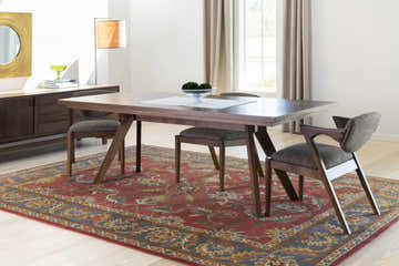 Dining room with a Charlottesville Tufted Wool Rug in brick red, dark brown, and navy under a wood table and chairs. Roomscene-Rectangle