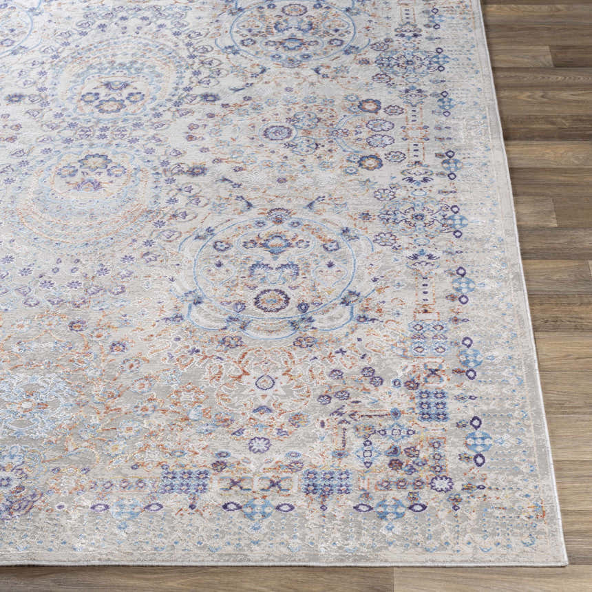 Close-up of the Aisha Abstract Premium Sheen Viscose Rug. Features blue, orange, and purple floral medallion pattern. Front