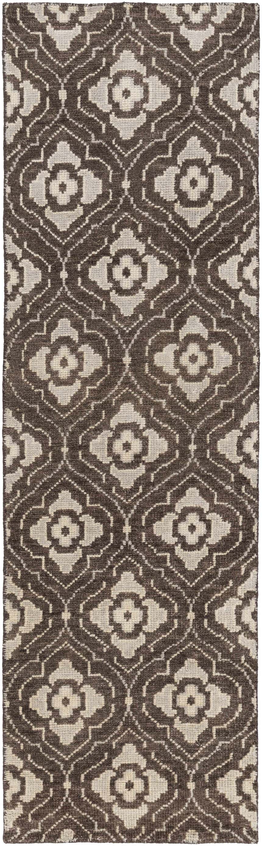 Close-up of the Claysville Area Rug. Beige and dark brown wool rug with a hand-knotted floral and geometric pattern. Design-Runner-268