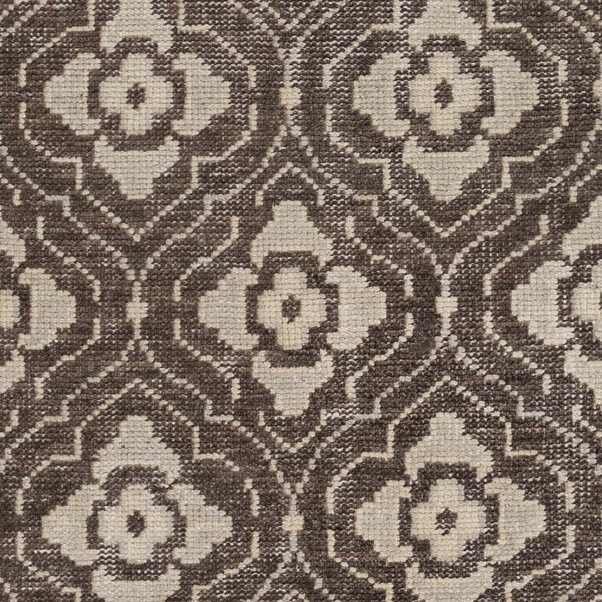 Close-up of the Claysville Area Rug. Beige and dark brown floral medallion pattern on a hand-knotted wool rug. Swatch