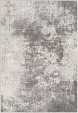 Close-up of the Calabasa Area Rug, featuring a contemporary abstract design in charcoal, gray, and light gray tones. Design-Rectangle-46