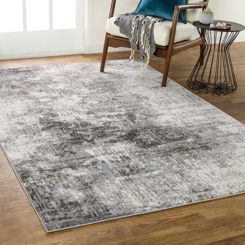 Living room scene with a charcoal and gray Calabasa Area Rug, wood chair, and modern side table. Roomscene-Rectangle