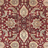 Close-up of the Coalinga Premium Wool Area Carpet showing its brick red color and traditional floral pattern. Swatch