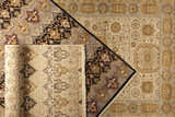 Close-up of the hand-knotted Owenton Area Rug. Features brick red, brown, and gray floral patterns on wool material. Styleshot