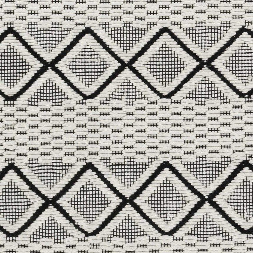 Close-up of the Cobourg Area Carpet. Black geometric diamonds on a cream, hand-woven wool rug. Contemporary farmhouse style. Swatch