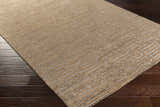 Close up of the brown Colona Area Carpet. Hand knotted viscose rug with a contemporary geometric pattern. Corner
