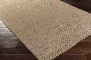 Close up of the brown Colona Area Carpet. Hand knotted viscose rug with a contemporary geometric pattern. Corner