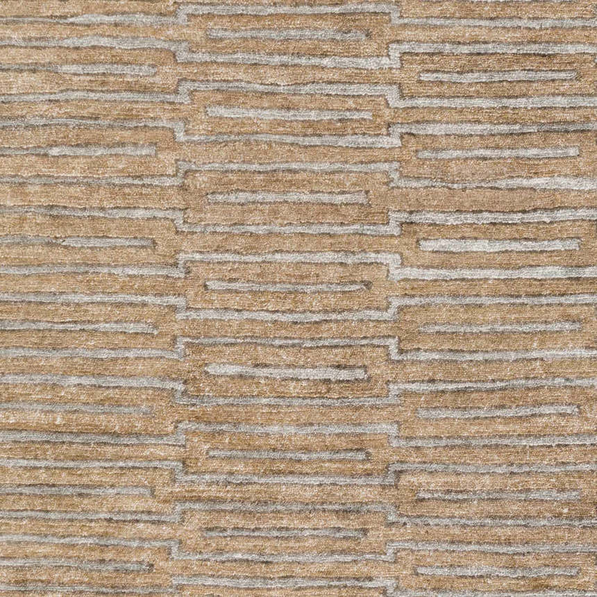 Close-up of the Colona Area Carpet. Brown rug with a contemporary geometric pattern in pale blue and dark red. Swatch