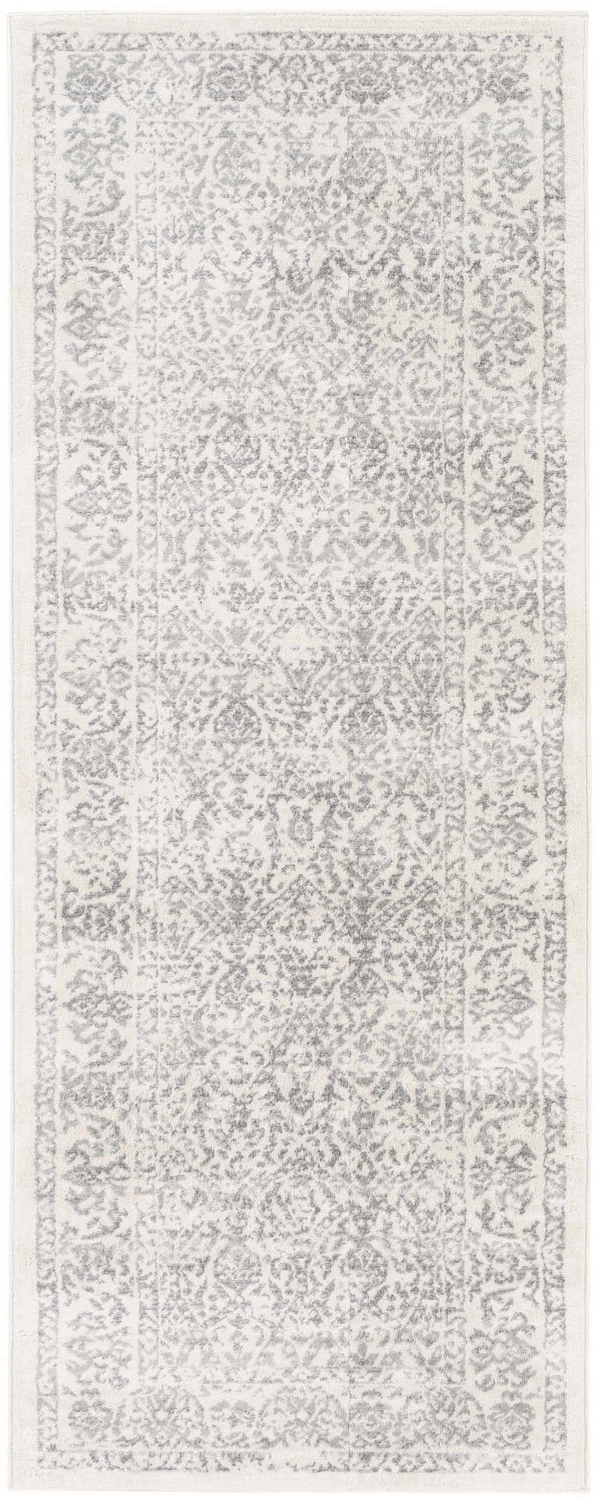 Close-up of the Comstock Area Rug. Machine-woven rug in charcoal, medium gray, off-white, and white gray. Bohemian style. Design-Runner-2710