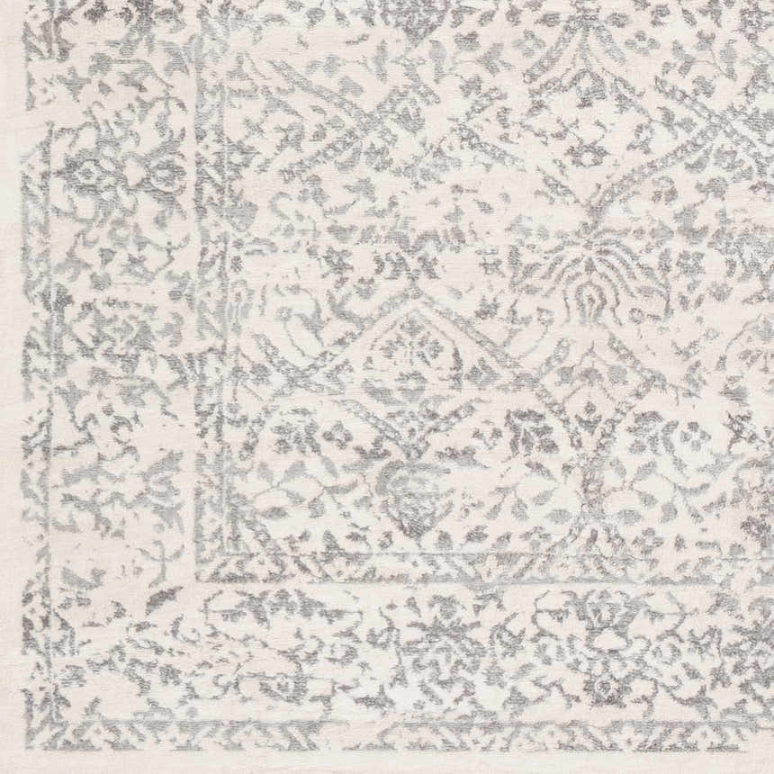 Close up of the Comstock Area Rug showing its charcoal and off white traditional pattern. Swatch