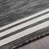 Close-up of the machine-woven Coonamble Bordered Antrasit Rug. Charcoal rug with cream striped border detail. Texture