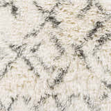 Close-up of the Cotgrave 2x3 Cream Trellis Wool Rug. Soft, shag texture with a subtle geometric trellis design in cream and gray. Swatch