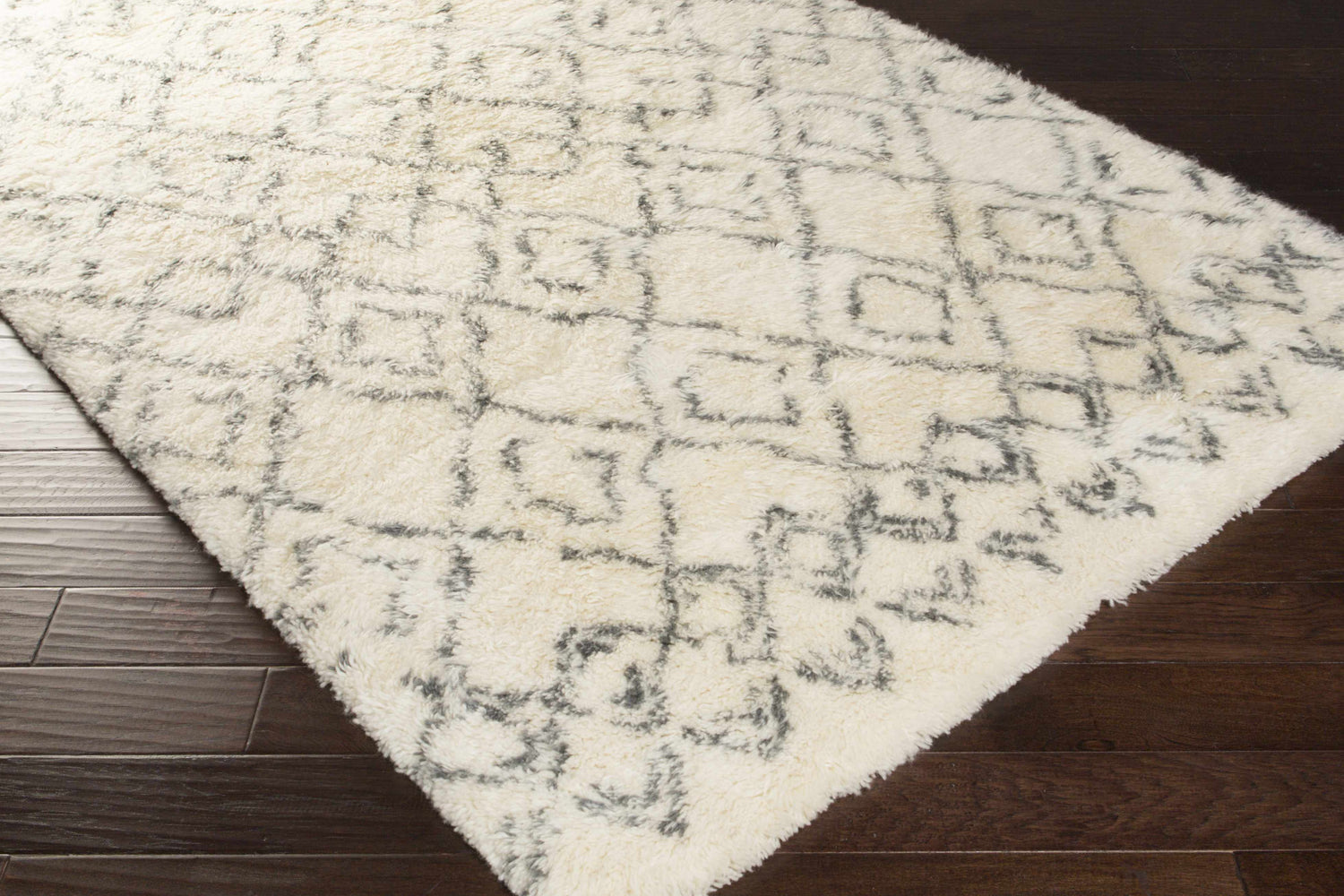 Close-up of the Cotgrave 2x3 Cream Trellis Wool Rug showing its shag texture and geometric trellis pattern. Corner