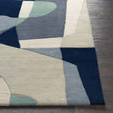 Close up of the Crawfordsville rug showing its geometric pattern in dark blue, denim, dusty sage, and oatmeal wool. Front