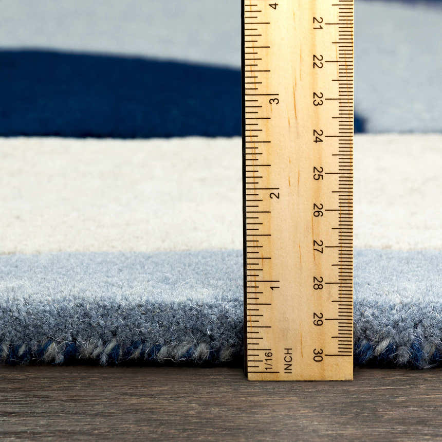 Close-up of Crawfordsville Rug showing pile height. Hand-tufted wool rug in dark blue, denim, and oatmeal stripes. Pile
